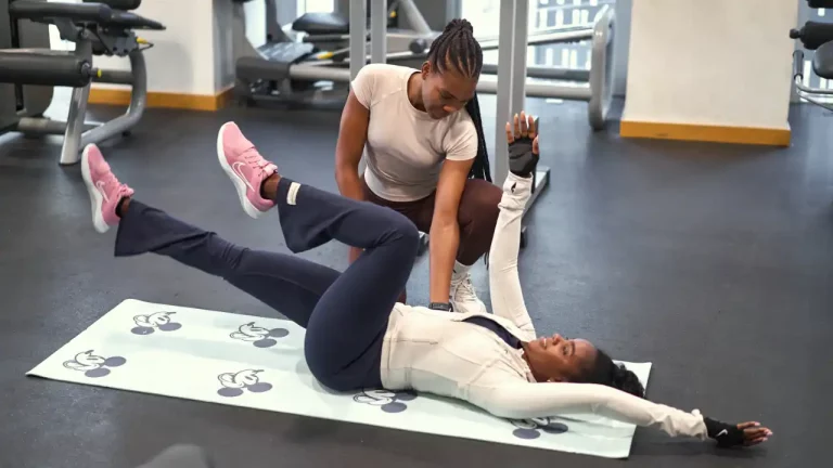 Fit with Rozzie personal trainer guiding a client during exercises in a building gym in Dubai Marina